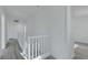 Upstairs hallway with neutral paint, modern flooring, and white railing at 3644 Shanagolden St, Las Vegas, NV 89129