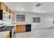 Kitchen area features stainless steel appliances, wood cabinetry, and wood-look flooring at 3644 Shanagolden St, Las Vegas, NV 89129