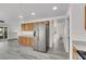 Spacious kitchen area flows into other rooms; features stainless appliances and wood-look floors at 3644 Shanagolden St, Las Vegas, NV 89129
