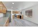 Well-lit kitchen features stainless steel appliances, wood cabinetry, and wood-look flooring at 3644 Shanagolden St, Las Vegas, NV 89129