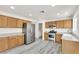 Modern kitchen features stainless steel appliances, wood cabinetry, and wood-look flooring at 3644 Shanagolden St, Las Vegas, NV 89129