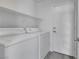 Functional laundry room equipped with a washer, dryer, storage shelves, and access to outdoors at 3644 Shanagolden St, Las Vegas, NV 89129