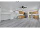 Open-concept living room features hardwood floors, natural lighting, and ceiling fan at 3644 Shanagolden St, Las Vegas, NV 89129