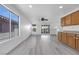 Open living area showcases wood-look floors and ample natural light from sliding glass door and windows at 3644 Shanagolden St, Las Vegas, NV 89129