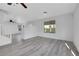 Bright living room with hardwood floors, ceiling fan, and serene views through large windows at 3644 Shanagolden St, Las Vegas, NV 89129