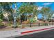 Community playground with colorful play structures, surrounded by lush trees and greenery, perfect for Gathering fun at 3644 Shanagolden St, Las Vegas, NV 89129