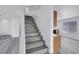 Bright entryway features a staircase with modern gray wood-look flooring at 3644 Shanagolden St, Las Vegas, NV 89129