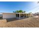 Home featuring backyard with stone landscaping, large covered patio, and block wall at 3700 Hickey Ave, North Las Vegas, NV 89030