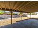 View of the backyard patio with stone landscaping, shade covering and block wall at 3700 Hickey Ave, North Las Vegas, NV 89030