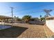 Spacious backyard with rock landscaping, covered patio and block perimeter wall at 3700 Hickey Ave, North Las Vegas, NV 89030
