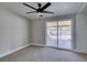 Cozy bedroom with carpet flooring, ceiling fan, and sliding glass doors overlooking the backyard at 3700 Hickey Ave, North Las Vegas, NV 89030