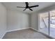 This cozy bedroom features carpet and a ceiling fan with a sliding glass door to the back at 3700 Hickey Ave, North Las Vegas, NV 89030