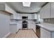 Updated kitchen with white cabinets, stainless steel appliances, and modern countertops at 3700 Hickey Ave, North Las Vegas, NV 89030