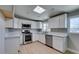 Modern kitchen featuring white cabinets, stainless steel appliances, and a bright, airy atmosphere at 3700 Hickey Ave, North Las Vegas, NV 89030