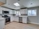 Updated kitchen with stainless steel appliances, white cabinets, and a skylight for natural light at 3700 Hickey Ave, North Las Vegas, NV 89030