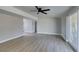 Living room boasting wood floors, neutral paint, ceiling fan, and sliding doors to the backyard at 3700 Hickey Ave, North Las Vegas, NV 89030