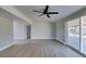 Large living area with new floors, fresh paint, ceiling fan, and sliding glass doors to backyard at 3700 Hickey Ave, North Las Vegas, NV 89030