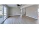 Spacious living room featuring light-colored wood floors, a ceiling fan, and sliding glass doors at 3700 Hickey Ave, North Las Vegas, NV 89030