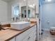 Bathroom featuring a modern sink, wood countertop and framed mirror at 386 Summer Creek Ct, Henderson, NV 89002