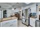Open-concept kitchen with stainless steel appliances and butcher block island flows into the dining area at 386 Summer Creek Ct, Henderson, NV 89002