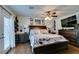 Spacious main bedroom with dark wood furniture, ceiling fan, and outdoor access at 386 Summer Creek Ct, Henderson, NV 89002