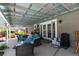 Covered patio with outdoor seating area overlooking the lush backyard and pool at 386 Summer Creek Ct, Henderson, NV 89002