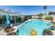 Sparkling pool with a sun-soaked patio, landscaping, and a covered lounge area, perfect for entertaining at 386 Summer Creek Ct, Henderson, NV 89002