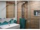 Modern bathroom featuring wood-look tile shower, rain shower head, and stylish vanity with backsplash at 4012 Vegas Dr, Las Vegas, NV 89108