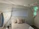 Cozy bedroom featuring a unique cloud light fixture, neutral tones, and accent brick wall at 4012 Vegas Dr, Las Vegas, NV 89108