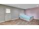 Cozy bedroom featuring a large bed with storage drawers, wood floors and brick wall at 4012 Vegas Dr, Las Vegas, NV 89108
