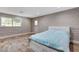 Bedroom features wood-look flooring, exposed brick accent wall, and large window for natural light at 4012 Vegas Dr, Las Vegas, NV 89108