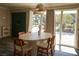 Bright dining room with modern lighting, wood floors, and view to the greenery outside at 4012 Vegas Dr, Las Vegas, NV 89108