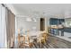 Modern dining area open to kitchen featuring stylish pendant lights and wood floors at 4012 Vegas Dr, Las Vegas, NV 89108