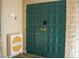 Stylish double front door in turquoise with modern hardware and adjacent shoe cabinet at 4012 Vegas Dr, Las Vegas, NV 89108