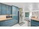 Open kitchen with modern blue cabinets, butcher block countertops, and stainless steel appliances at 4012 Vegas Dr, Las Vegas, NV 89108