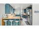 Modern kitchen featuring stylish blue cabinetry, stainless steel appliances, and a butcher block island at 4012 Vegas Dr, Las Vegas, NV 89108