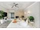 Bright living room features fireplace, brick wall, and modern ceiling fan at 4012 Vegas Dr, Las Vegas, NV 89108