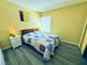 Well-lit bedroom with gray floors, bedside lamps, and a comfortable quilt at 4016 Calle Paula, Las Vegas, NV 89103
