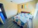 Well-lit bedroom with gray floors, bedside lamps, closet and a comfortable quilt at 4016 Calle Paula, Las Vegas, NV 89103