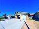 Charming single-story home featuring an attached garage and well-lit driveway at 4016 Calle Paula, Las Vegas, NV 89103