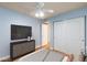 Bright bedroom features a ceiling fan, closet with doors, and light blue walls at 4050 Pacific Harbors Dr # 112, Las Vegas, NV 89121
