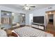 Bright bedroom features a mirrored closet, ceiling fan, and wood-look floors at 4050 Pacific Harbors Dr # 112, Las Vegas, NV 89121
