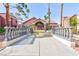 Charming condo community entrance with well-maintained grounds, mature trees, and a inviting walkway at 4050 Pacific Harbors Dr # 112, Las Vegas, NV 89121