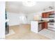 Open kitchen with stainless steel appliances, breakfast bar, and laminate flooring at 4050 Pacific Harbors Dr # 112, Las Vegas, NV 89121