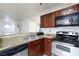 Updated kitchen featuring granite counters, stainless appliances, and laminate flooring at 4050 Pacific Harbors Dr # 112, Las Vegas, NV 89121