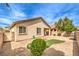 Home's backyard has desert landscaping, brick patio, small grass area, and a brick wall at 4071 Blue Manor Ln, North Las Vegas, NV 89032