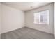 Carpeted room offers a bright window and neutral walls at 4071 Blue Manor Ln, North Las Vegas, NV 89032