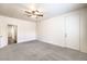 Spacious carpeted bedroom featuring a ceiling fan and bright white walls at 4071 Blue Manor Ln, North Las Vegas, NV 89032
