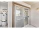 Exterior balcony features sliding glass doors, exterior light fixture, and closet housing the hot water tank at 45 Maleena Mesa St # 1424, Henderson, NV 89074
