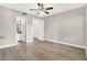 Spacious bedroom featuring wood look flooring, ceiling fan, and ensuite bathroom at 45 Maleena Mesa St # 1424, Henderson, NV 89074